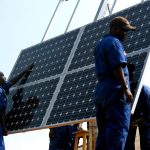 Training workers to install solar panels at health clinics in rw